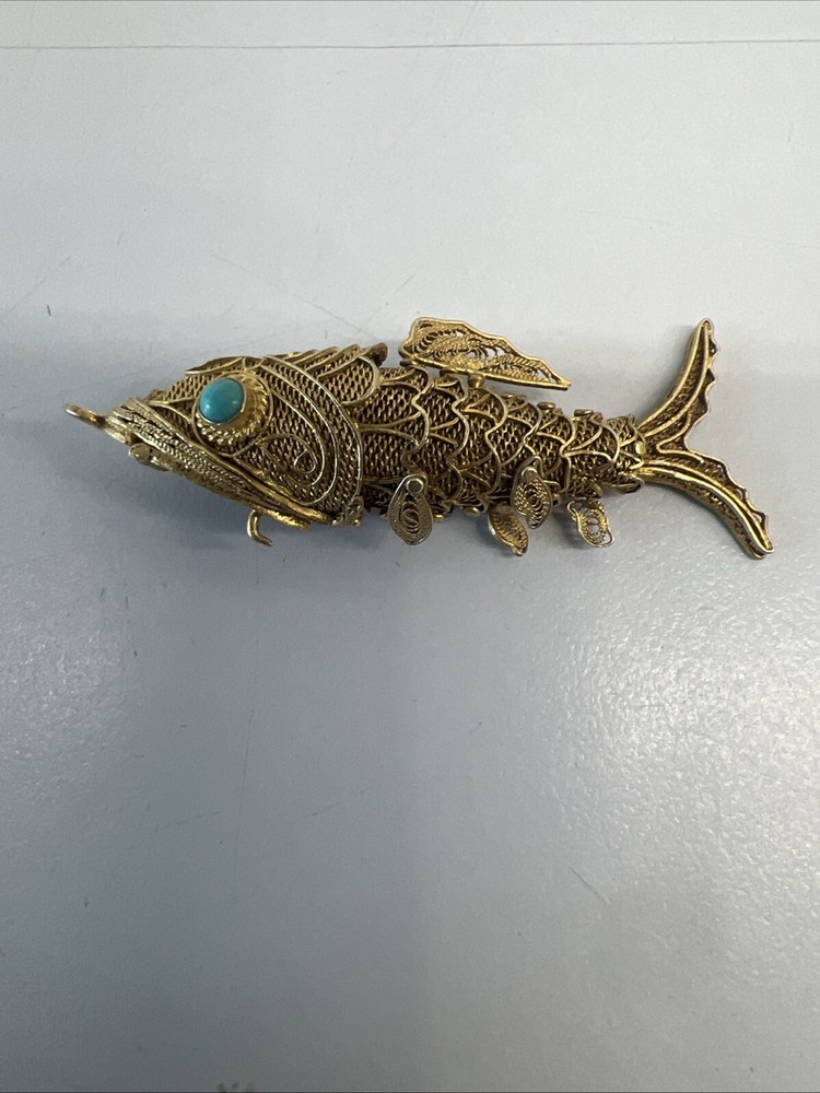Tested as silver and gilded flexible fish, possibly pill box.