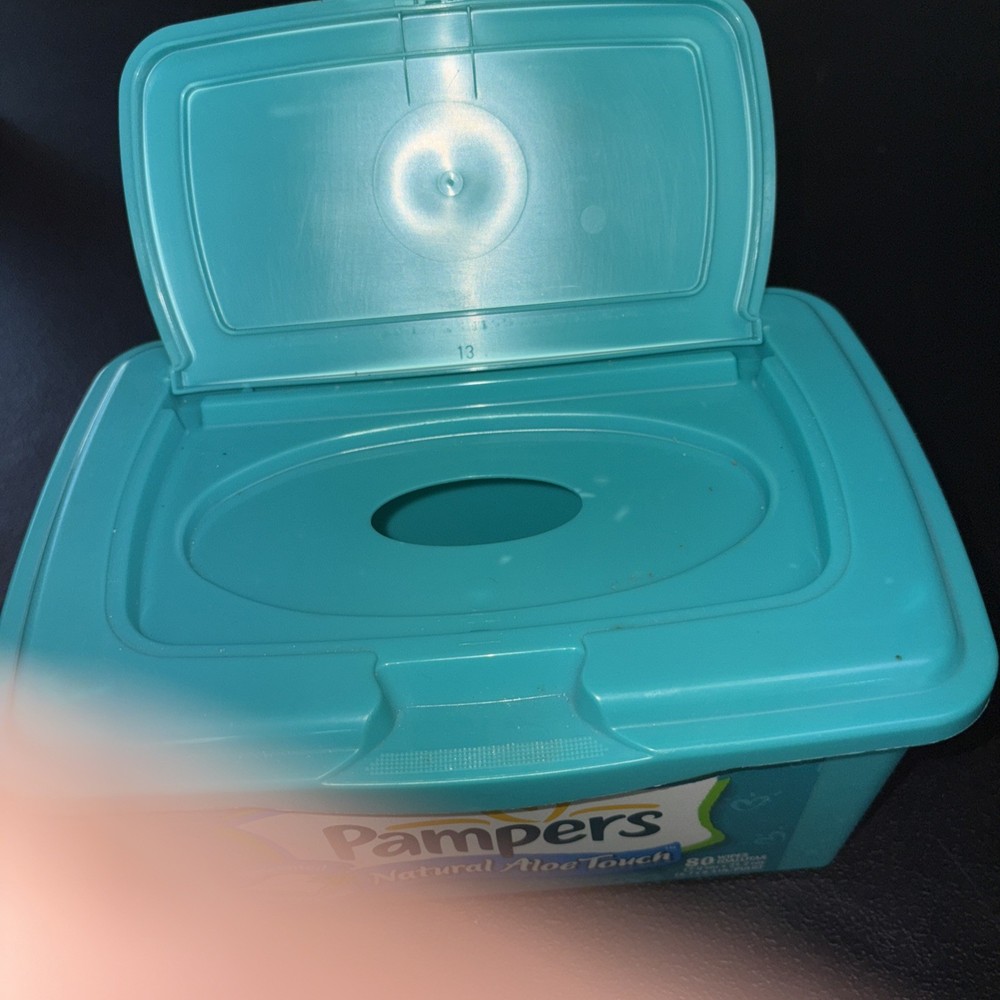 Empty Green Pampers Baby Wipes Container