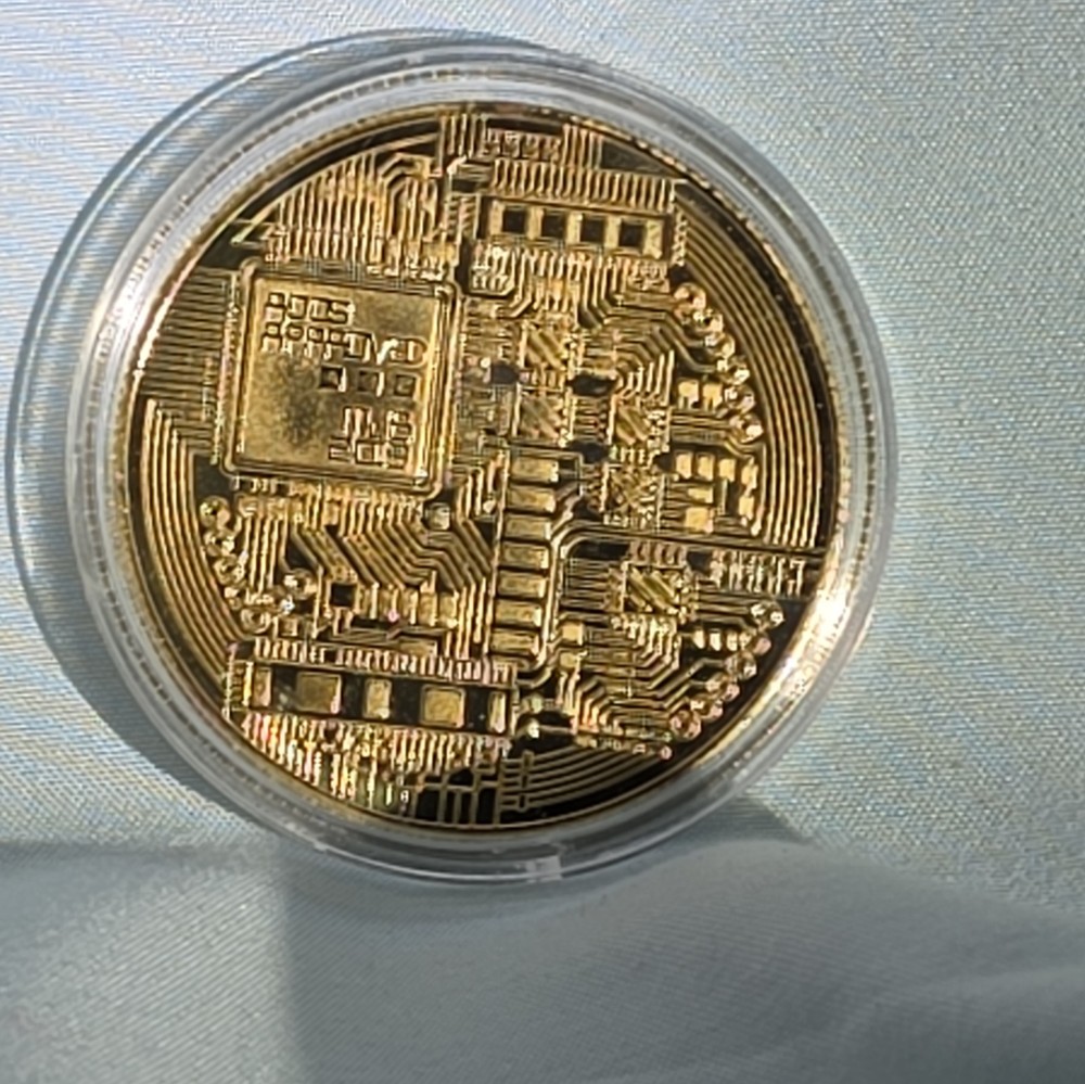 Bitcoin - gold colored Bitcoin in protective case.