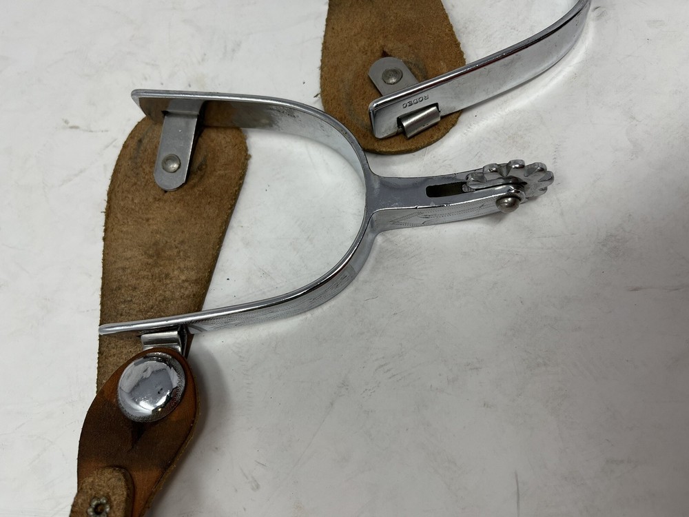 Silver Rodeo Spurs with Leather Straps and Rowels