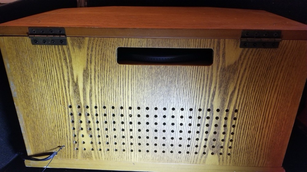 First-generation CD player with a brown color scheme and a belt drive system.