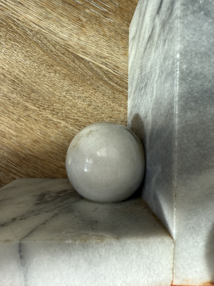 Vintage marble bookends with spherical elements.