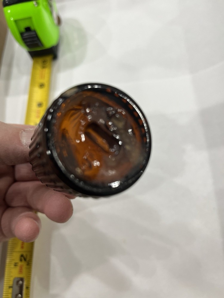 Small Amber Round Ribbed McKESSONS bottle
