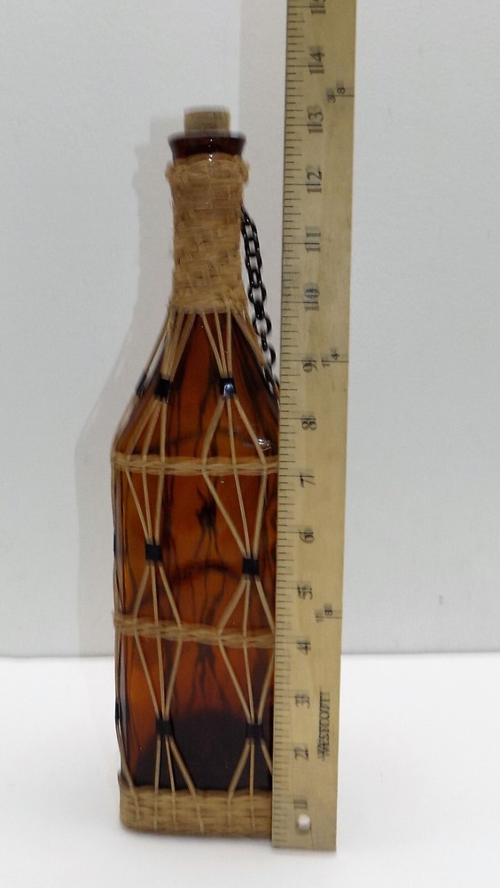 Vintage brown bottle braided with strings.