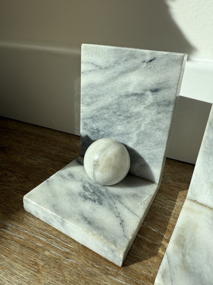 Vintage marble bookends with spherical elements.