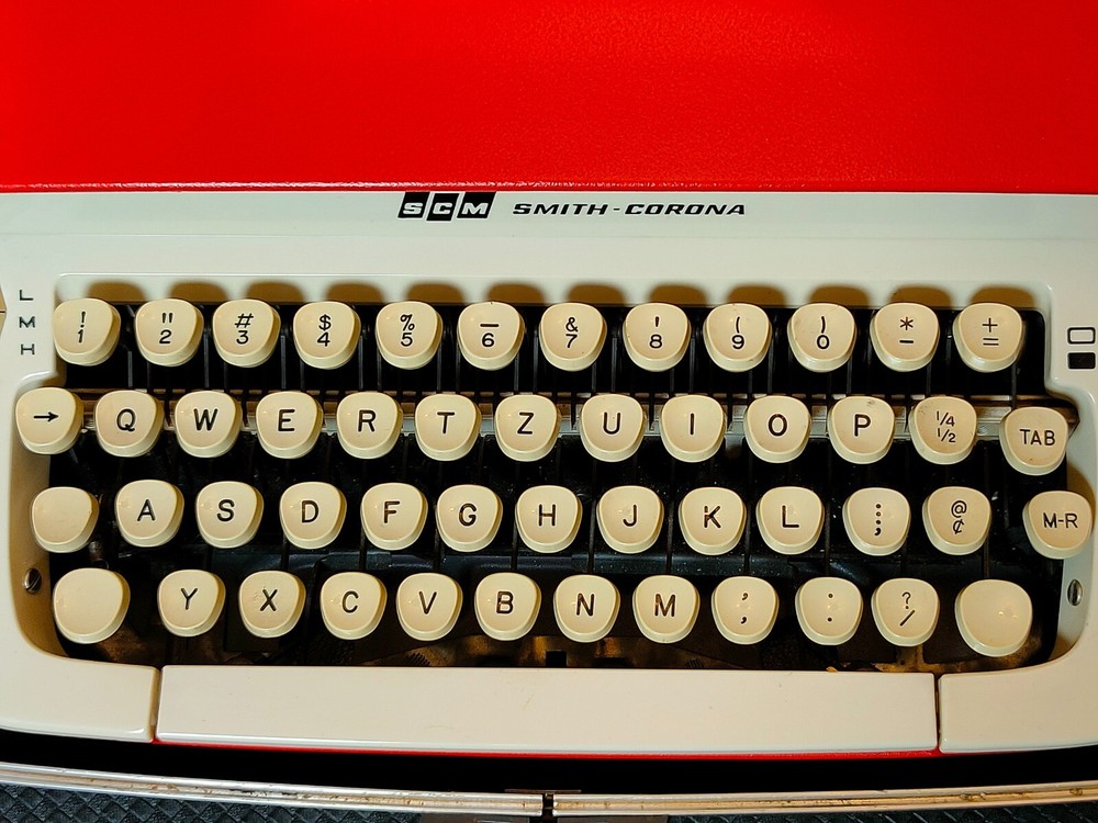 red, portable Smith Corona Galaxie typewriter with Cursive / Handwritten Script
