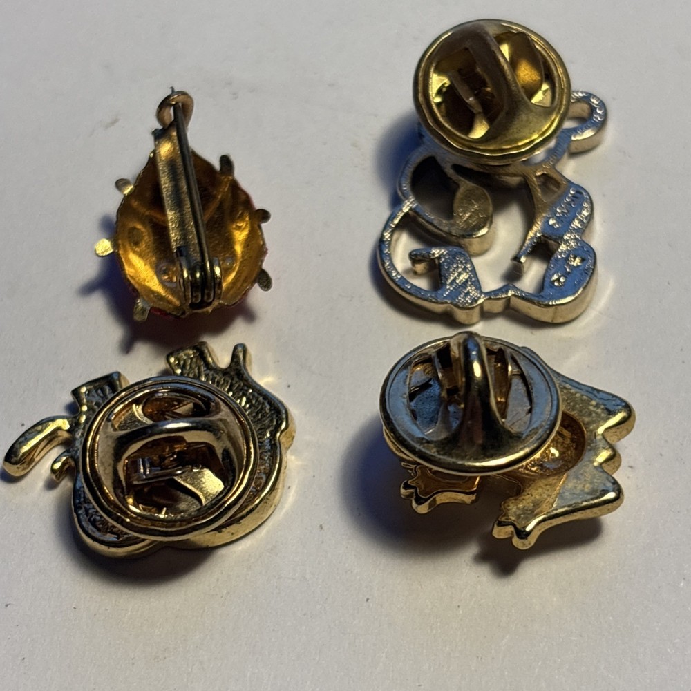Four Metal Badges.