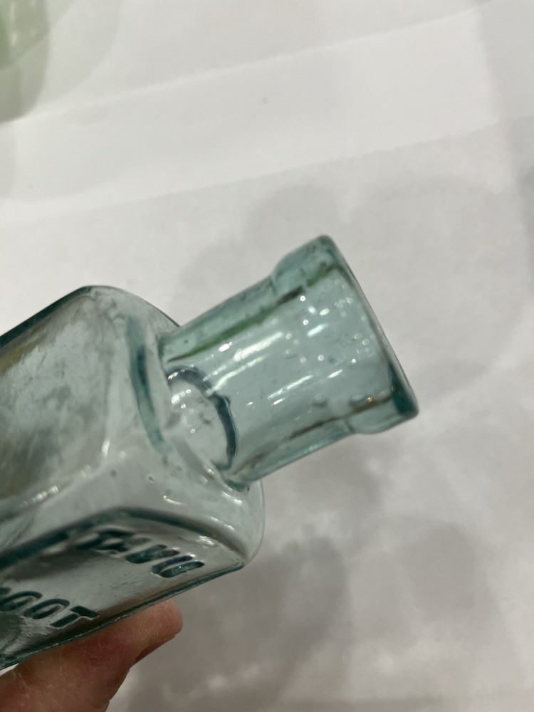 Embossed Aqua Kavu Boot Polish Bottle