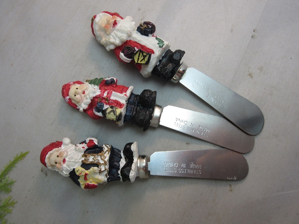Sculpted resin Santa handle cheese spreader knives