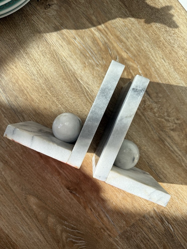 Vintage marble bookends with spherical elements.