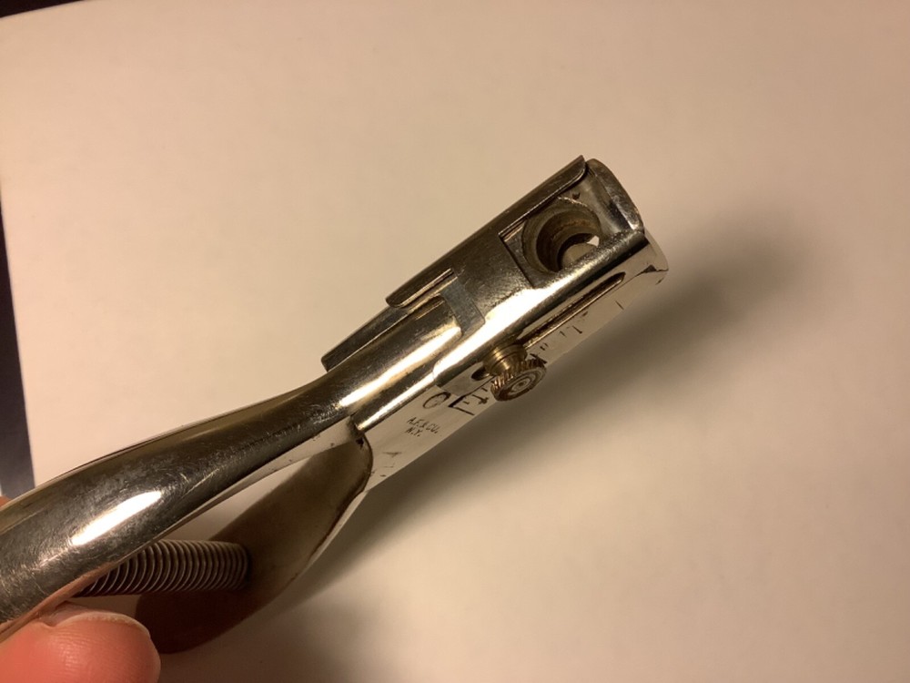 A.F. & Co. hole punch with spring handle action and adjustable punch depth guide