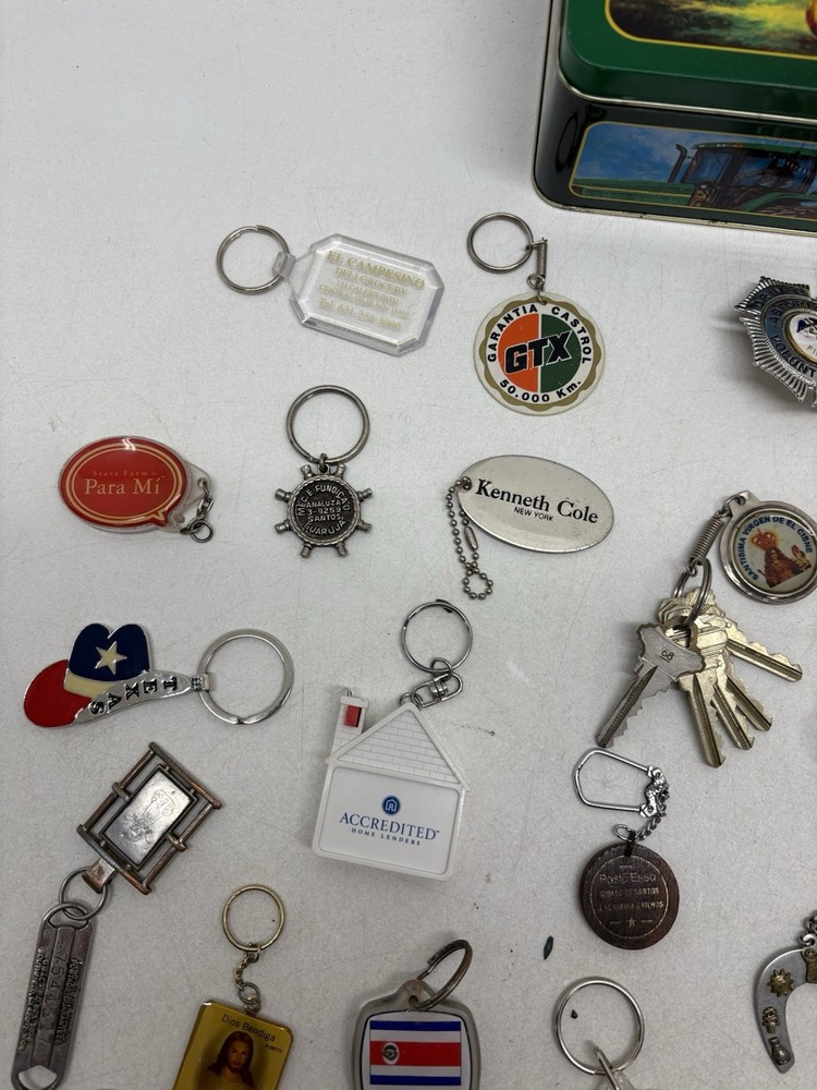 32 Vintage Key Chains And a John Deere Tin Box