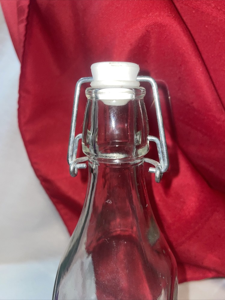 Clear bottle with latch lid- bottom has a b on it