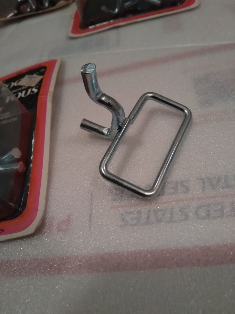 Lot of assorted NOS pegboard tool holders for 1/4" board