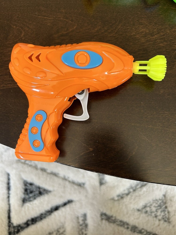 Manual trigger orange bubble blower gun