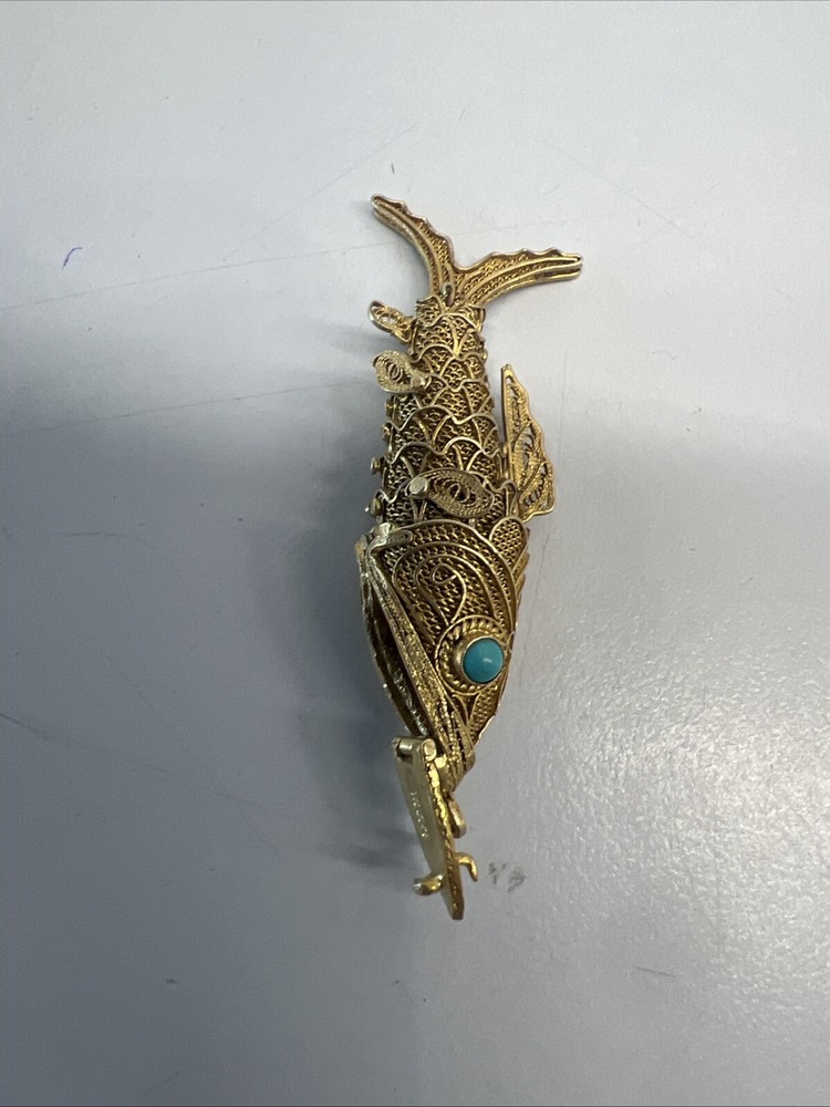 Tested as silver and gilded flexible fish, possibly pill box.