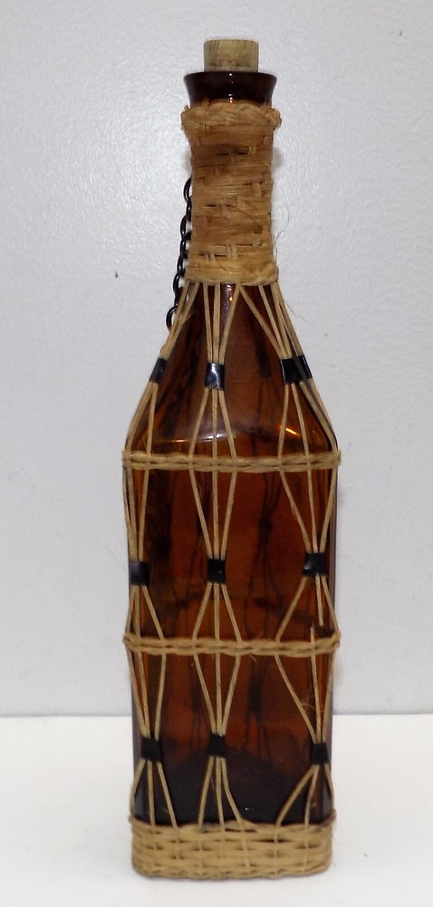 Vintage brown bottle braided with strings.