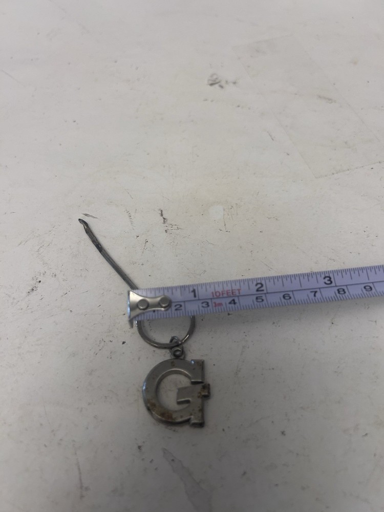 "G" keychain with small spoon scooper used