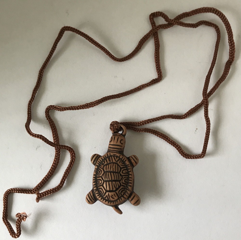 Resin turtle pendant with adjustable rope chain.