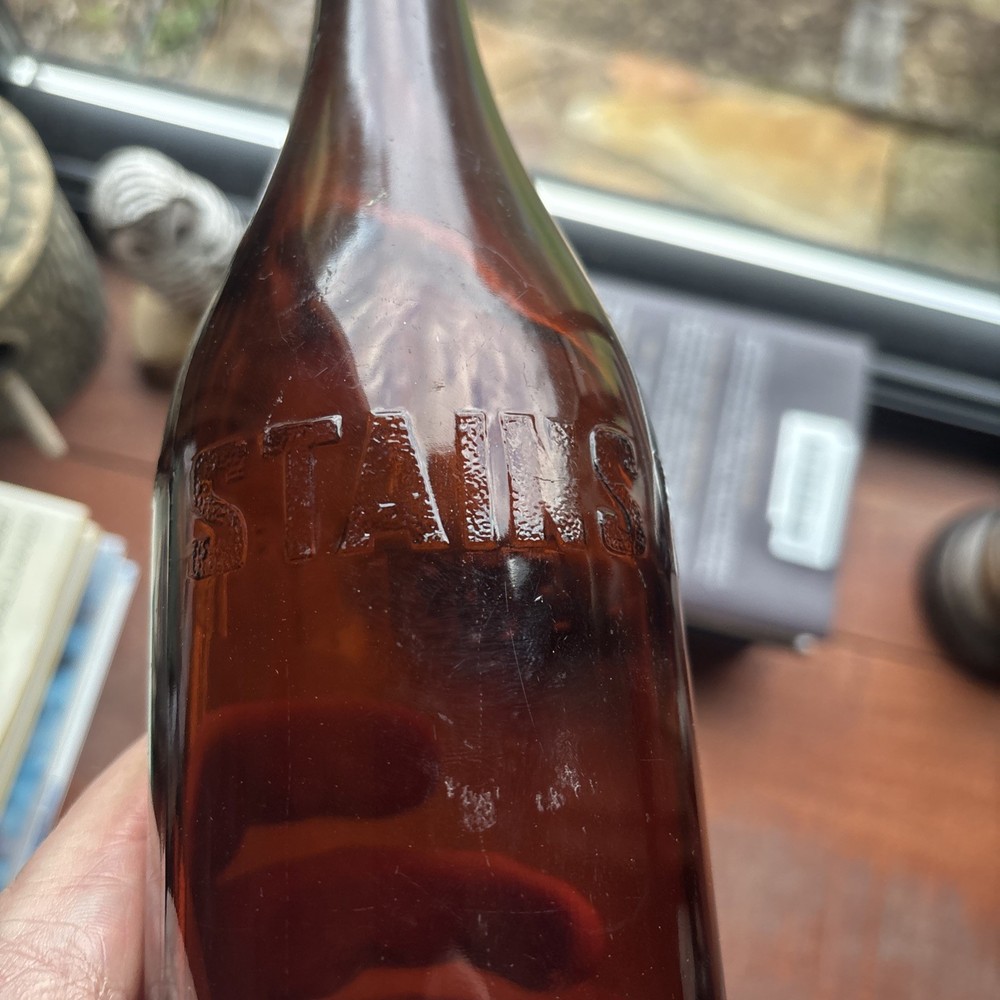 Stains Run From 101 Amber Embossed Bottle