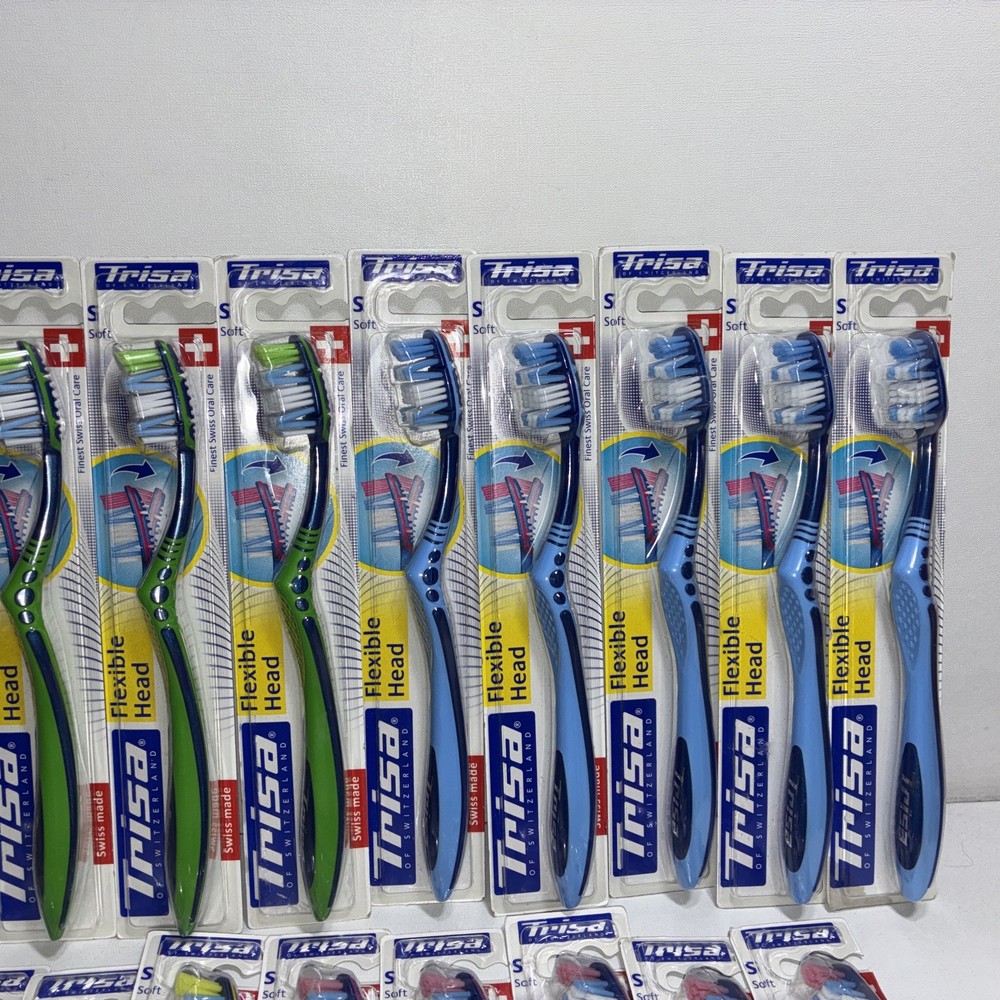 23 Trisa Flexible Head Toothbrushes/ All New