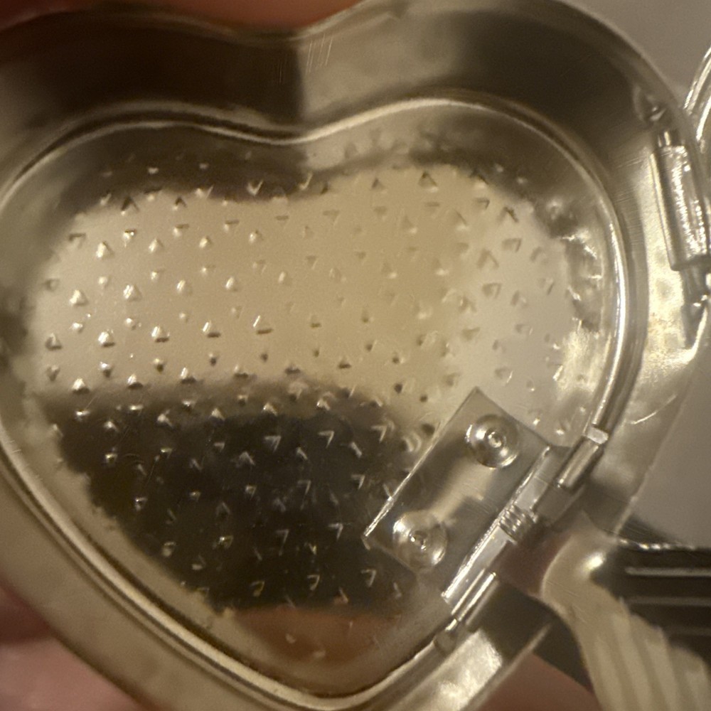 silver color pill box heart shape with leaf
