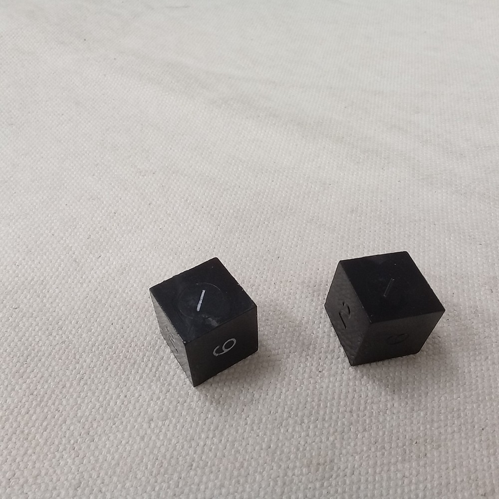 Gamescience dice, d6, pair, black, slanted #1, one inked in crayon