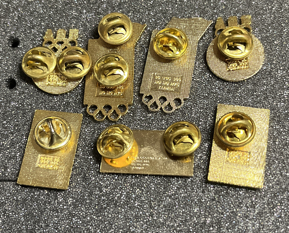 SEVEN (7) ASSORTED OLYMPICS PINS MERRILL LYNCH BULL