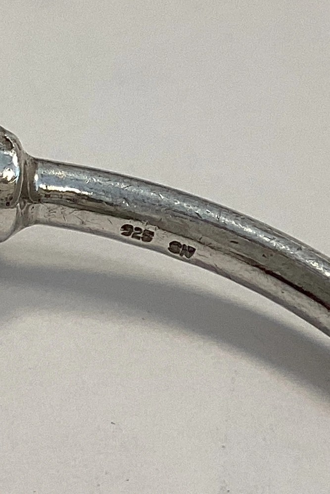 Modern open bangle in Sterling Silver with lion heads