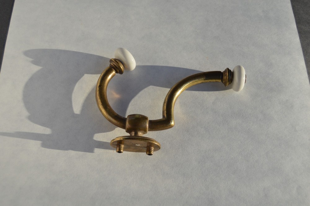 Solid brass with procelain hook that will hold securely is easy to mount .