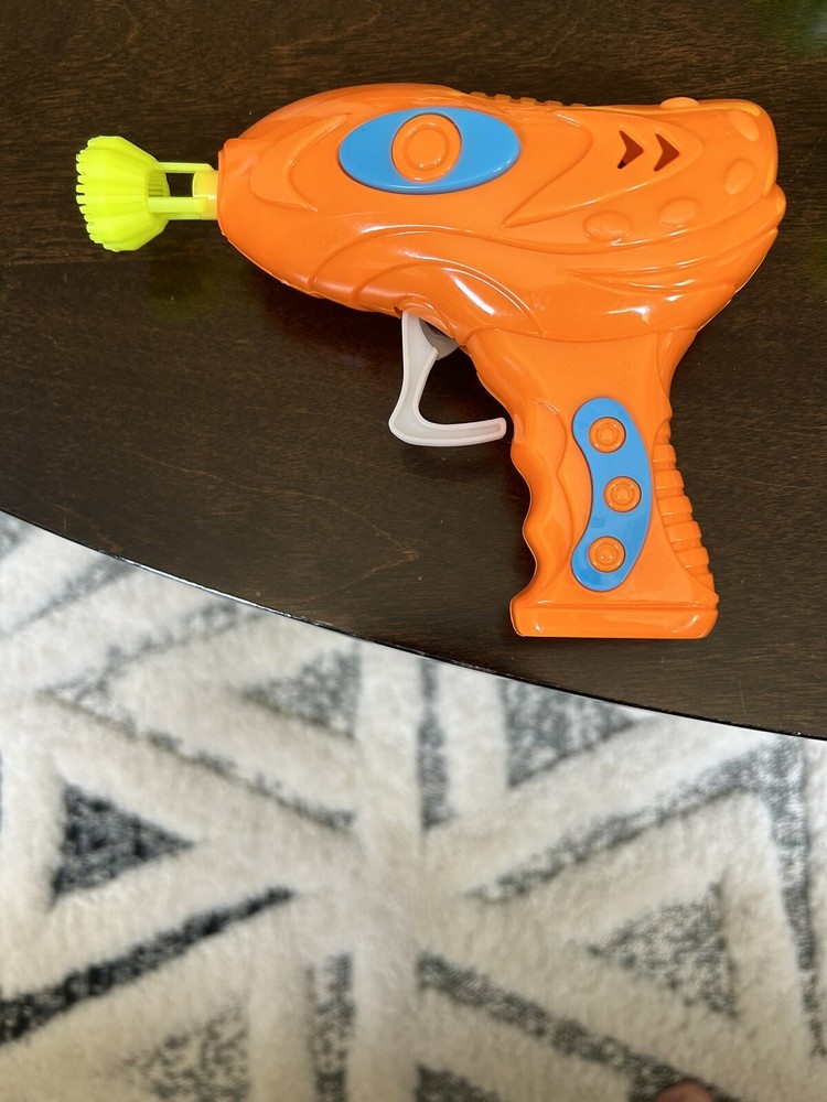Manual trigger orange bubble blower gun