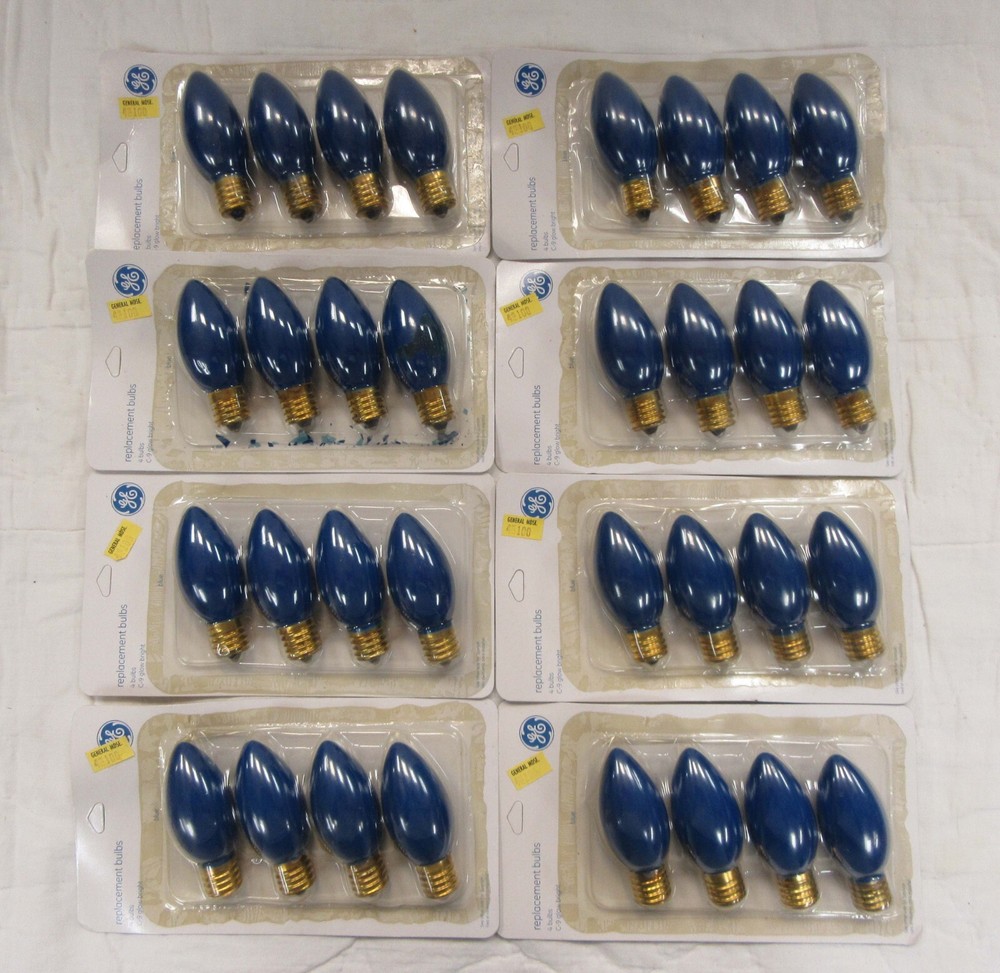 4 blue replacement C-9 bulbs. Intermediate base. 120 volt. 8 pks. available. NOS