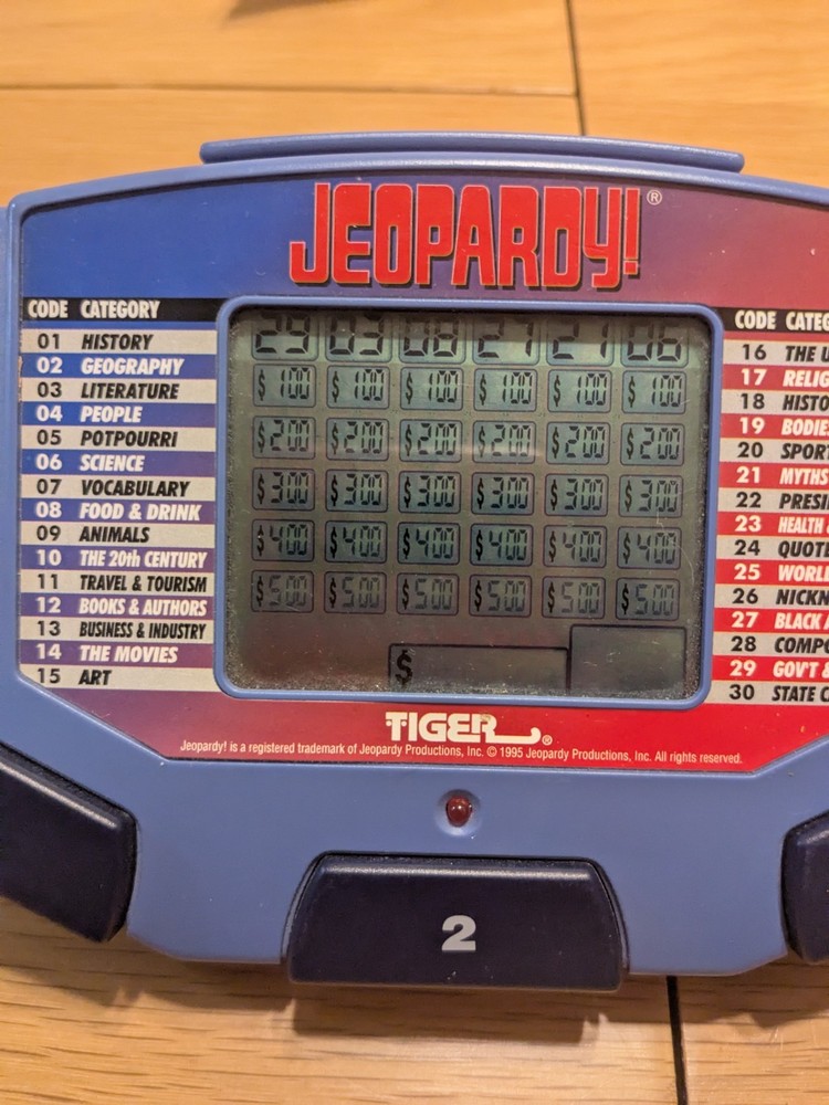 Tiger Electronics Jeopardy Hand Held Game 1995 with Answer Question Book