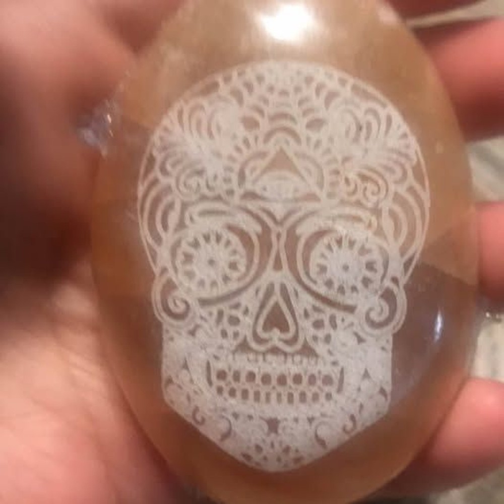 Orange selenite palm with skull