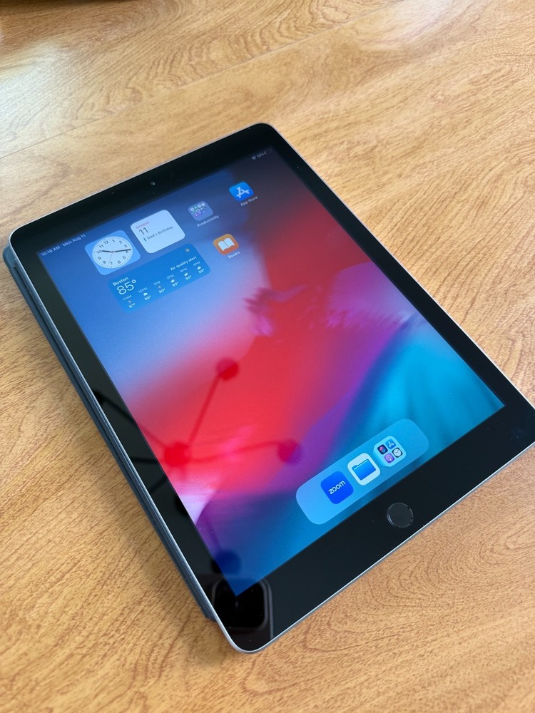 Gently used Apple iPad (5th generation) with Smart Folio case and charging cable