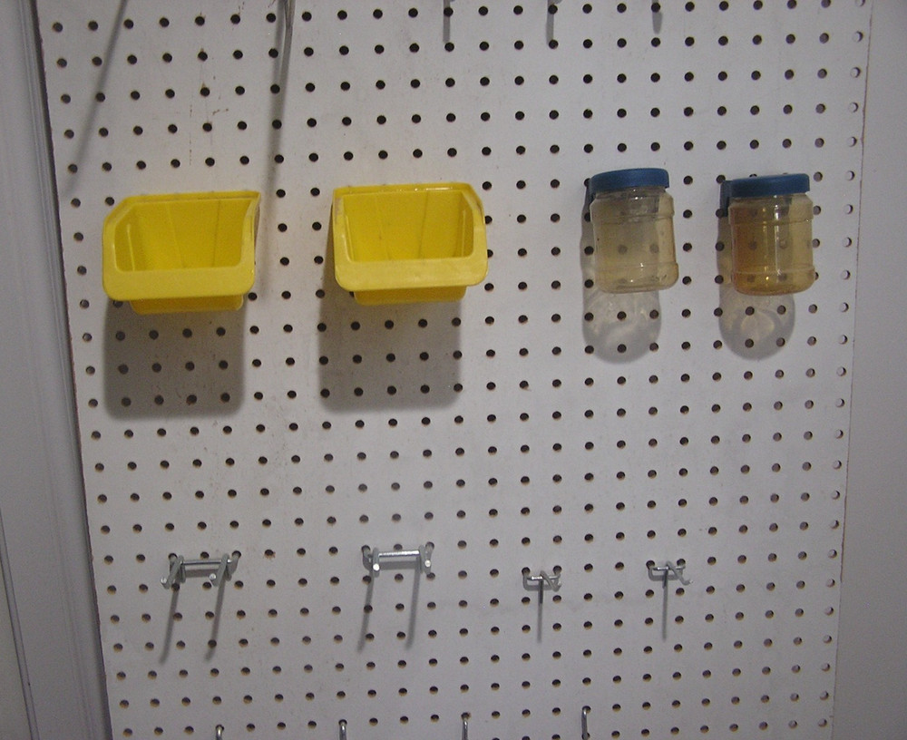 Composite Pegboard with Hooks and Bins Moounted