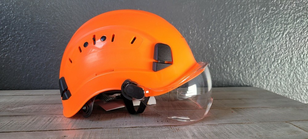 Arborist climber helmet with eye protection visor.