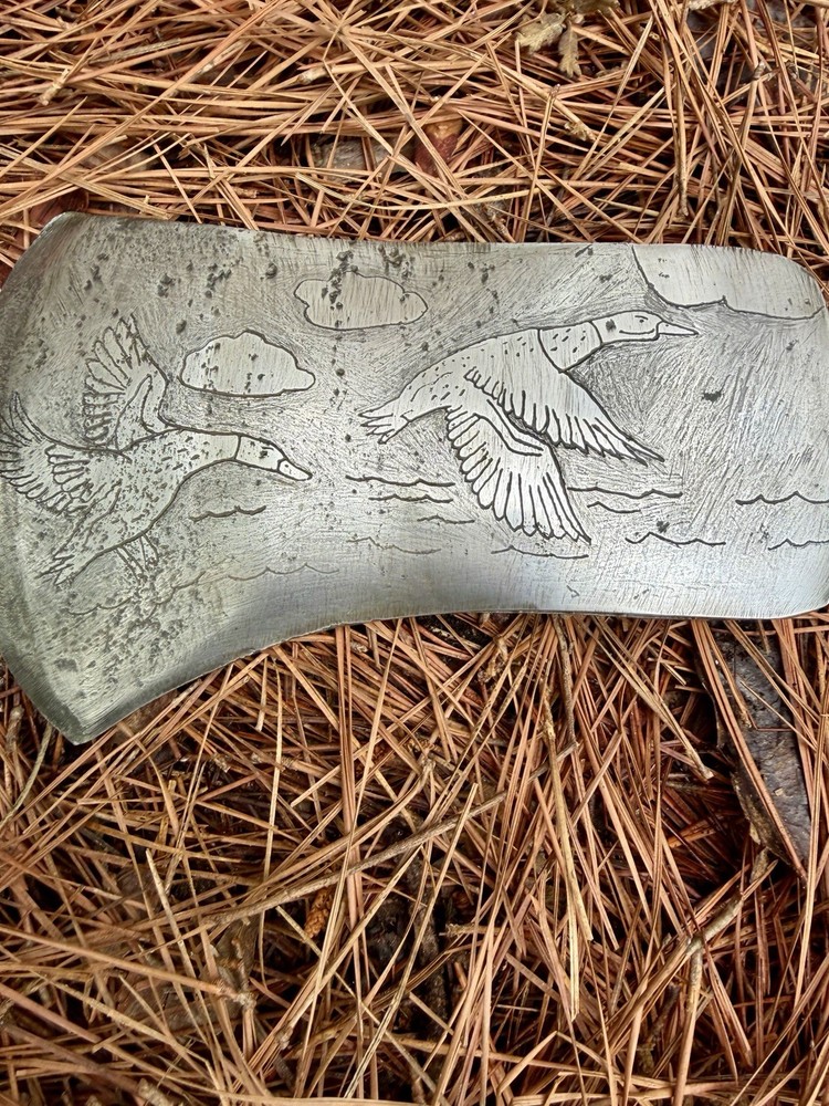 Single Bit Axe With A Duck Scenery Etched On Both Sides.