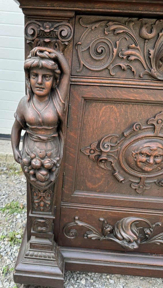 A. J. JOHNSON CARVED FIGURAL OAK SIDEBOARD