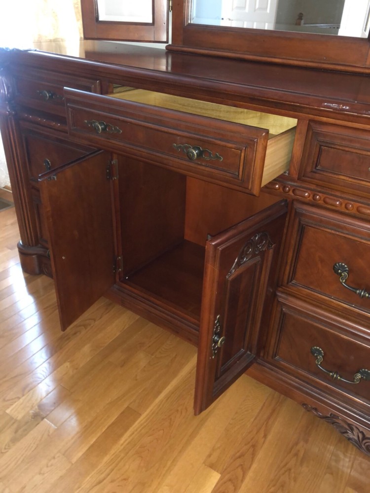 Brown dresser with adjustable three panel mirror.