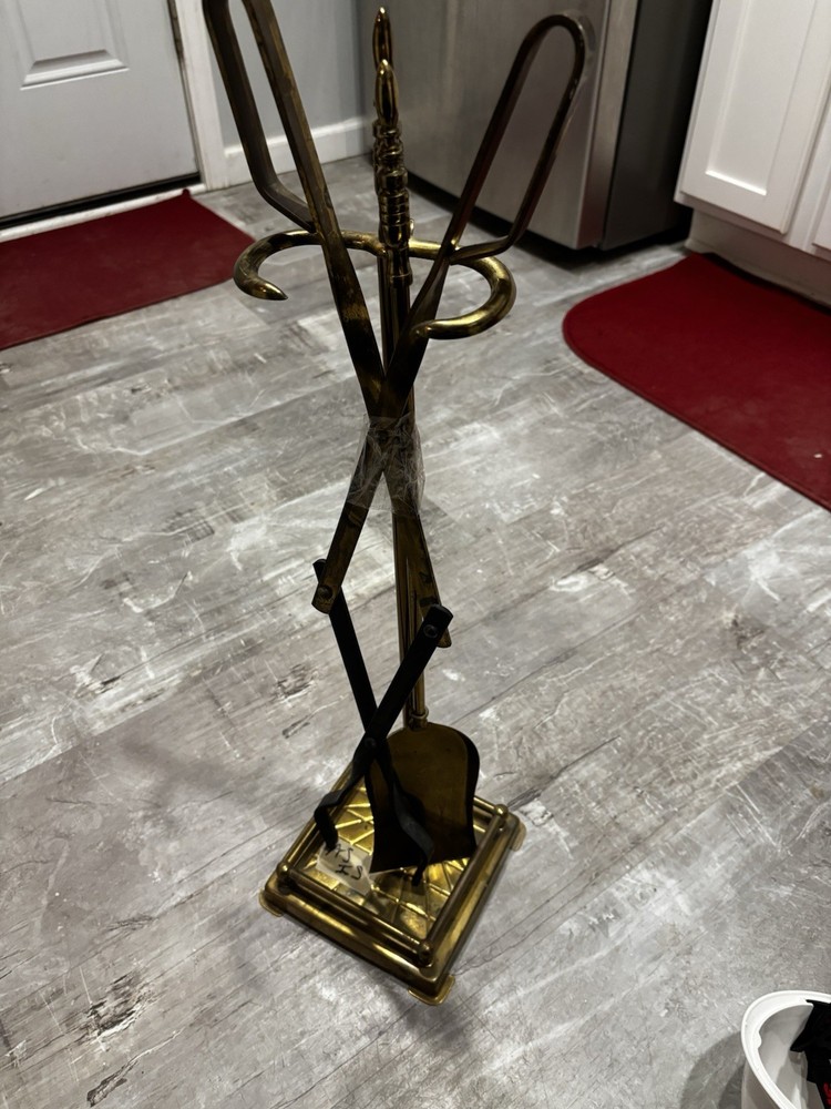 This item is a vintage brass fireplace tool set, typically featuring tools