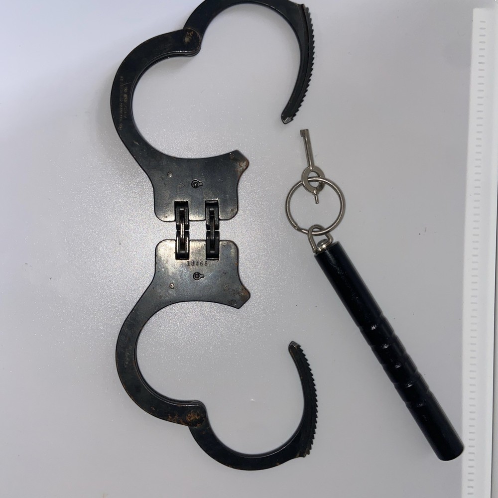Vintage Peerless Hinge-Linked Handcuffs & Key On Monadnock Persuader