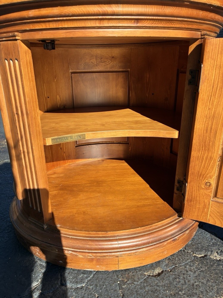 This Ethan Allen Tuscan Oval Cabinet Drum Table