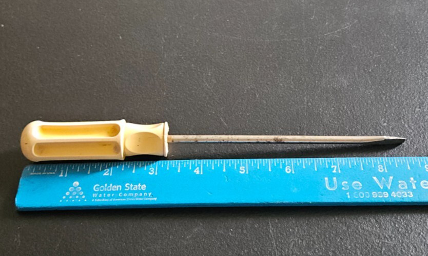 FLATHEAD SCREW DRIVER. WHITE DIMPLED PLASTIC HANDLE. UNMARKED