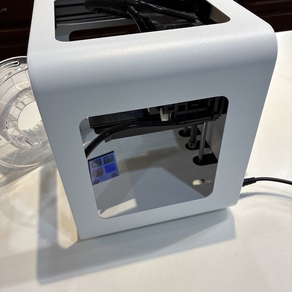 TOYBOX 3D Printer with white printer food.