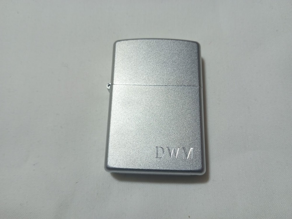 ---New unfired 2005 Zippo DWM monogram engraved lighter