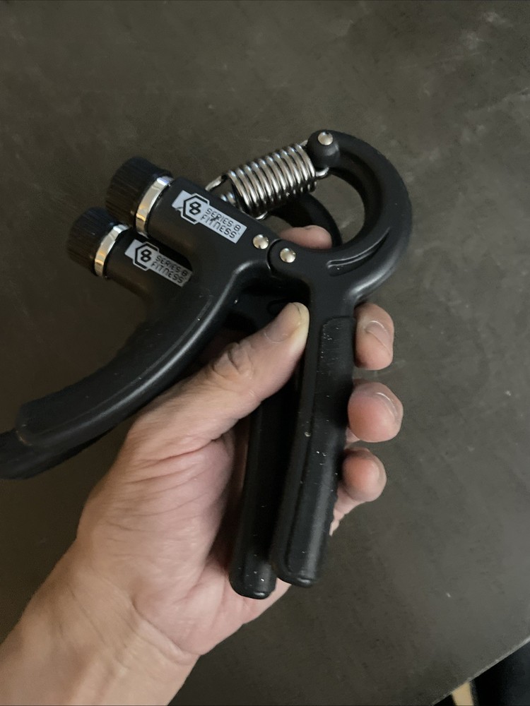 Two Handheld grip strength trainers - black - grey