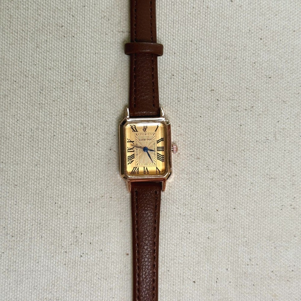 2000s vintage style rectangular gold luxury watch with leather band