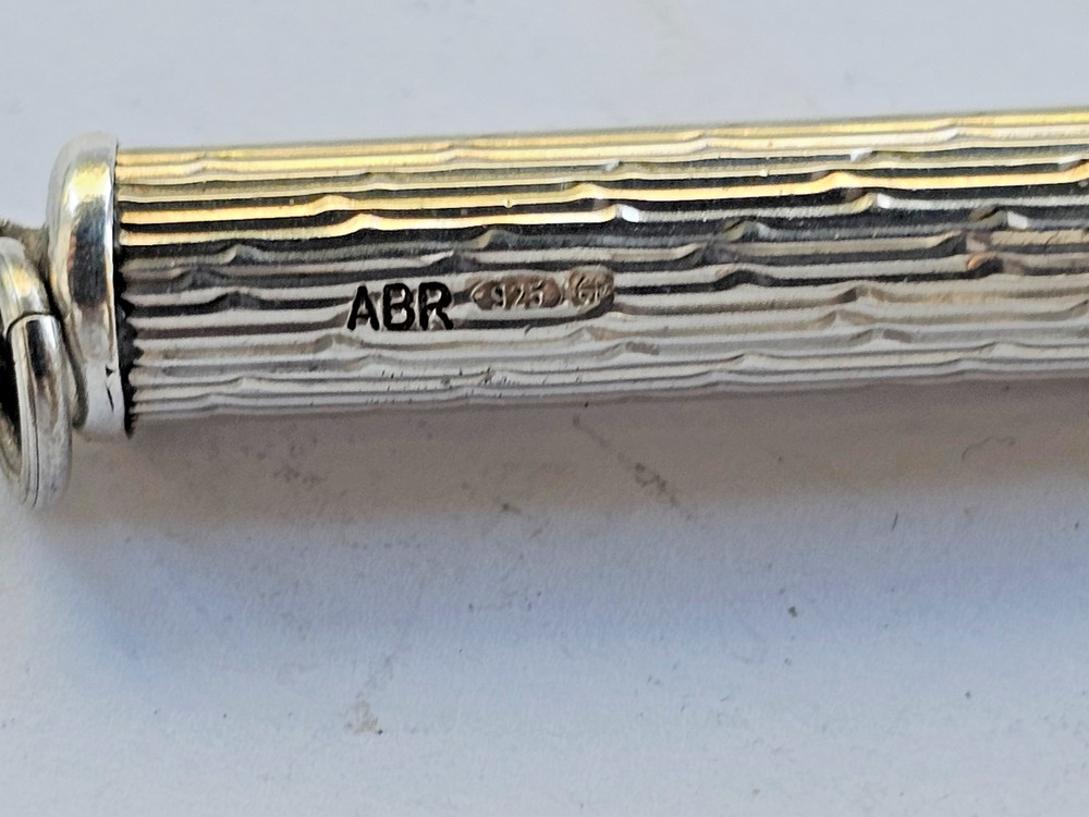 Engine turned silver tooth pick with plastic tool
