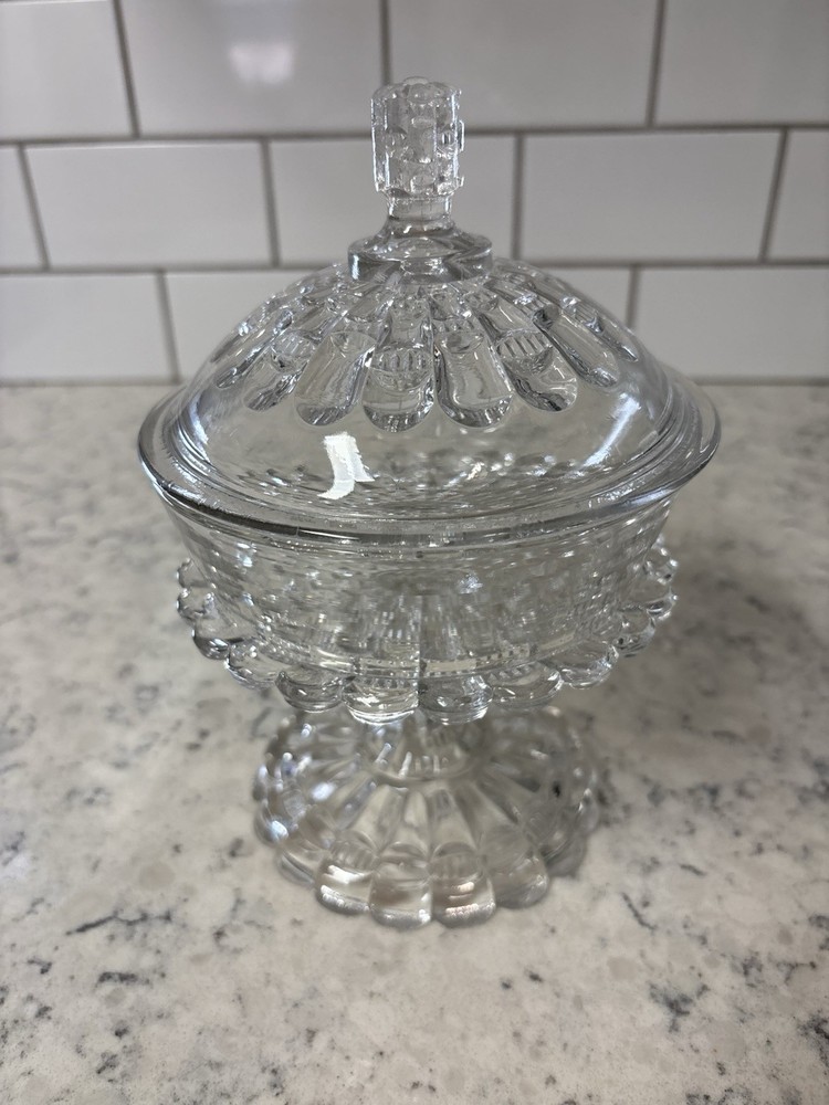Clear pressed glass covered compote in the 'Cut Log' pattern.